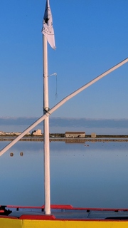 A flag in the middle of a blue sky
